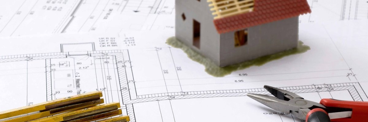 Symbolbild Gebäude planen Symbolbild Hausbauplanung mit Zollstock, Zange und Grafik